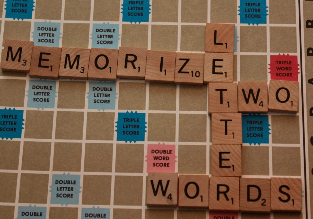 Scrabble letters arranged to advise memorizing two letter words.